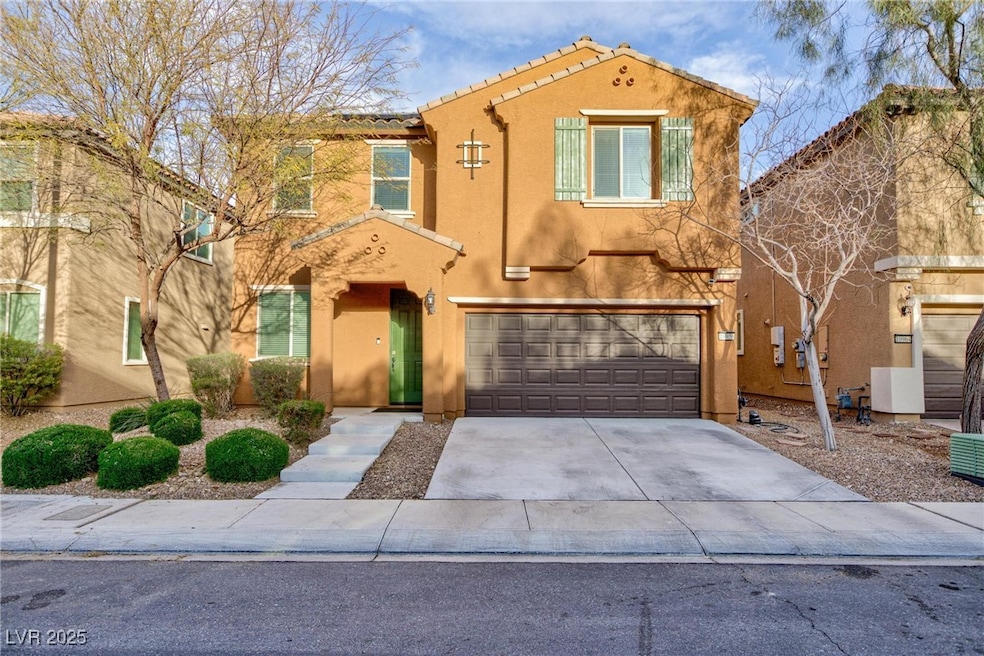 View of front facade featuring driveway, a tiled r