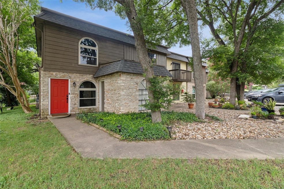 View of front of house featuring stone siding, a 