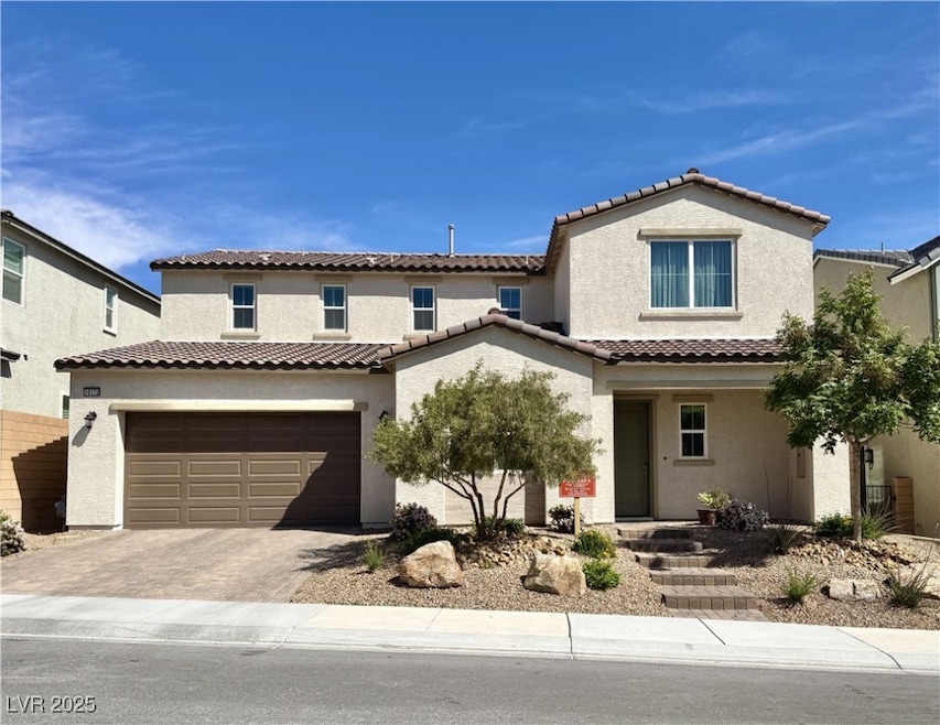 Mediterranean / spanish-style home featuring a gar