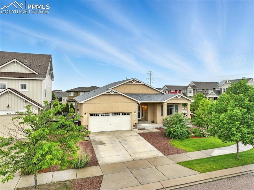 View of front facade featuring stucco siding, driveway, a garage, and a porch