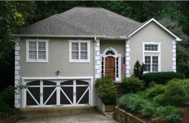 Exterior Front. Extensive landscaping with stone p