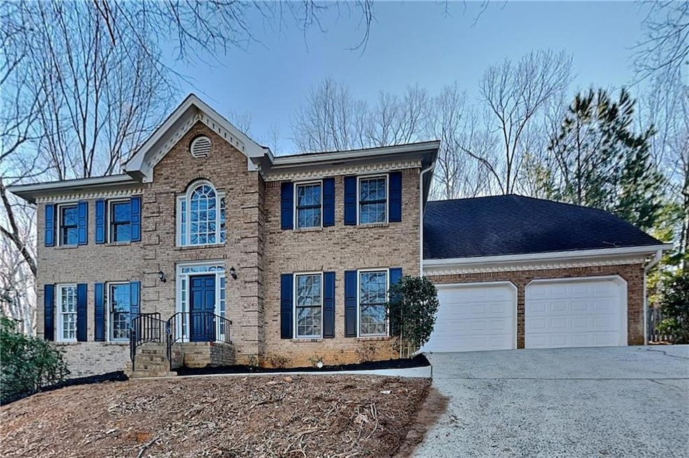 View of front of property with a garage, brick sid