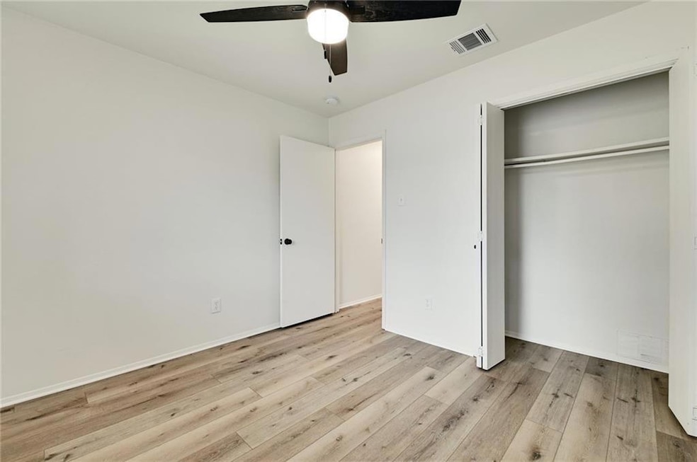 Unfurnished bedroom with wood finished floors, a 