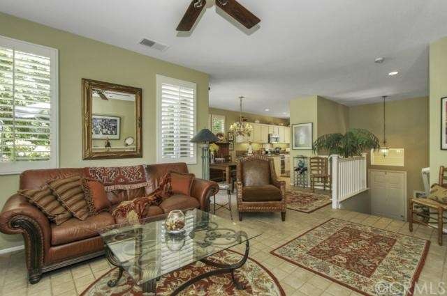 Open living room features stone like tile and a ce