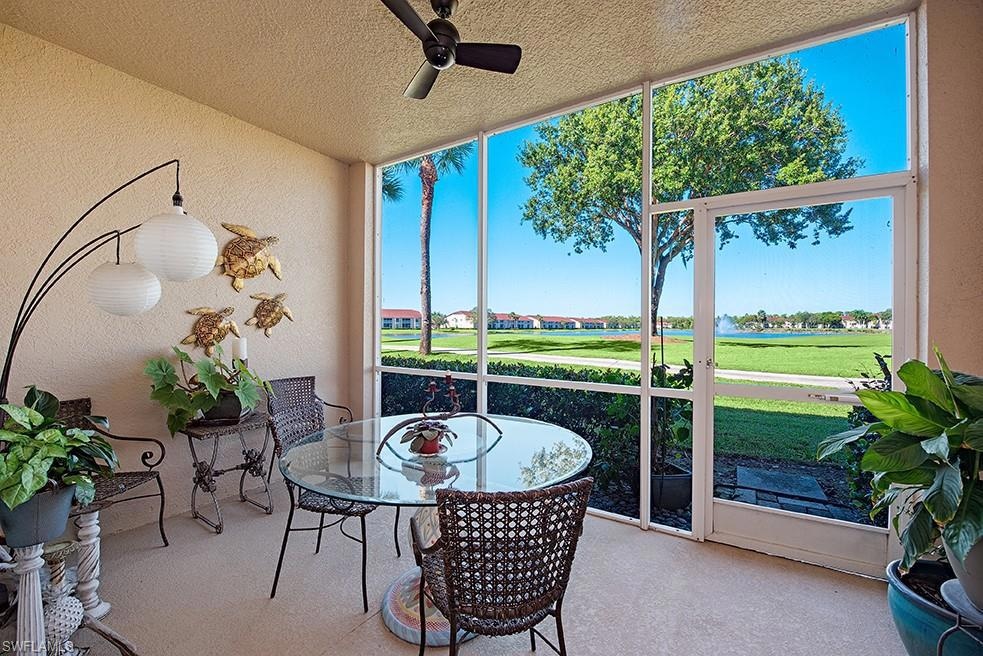 Sunroom / solarium with ceiling fan and view of golf course