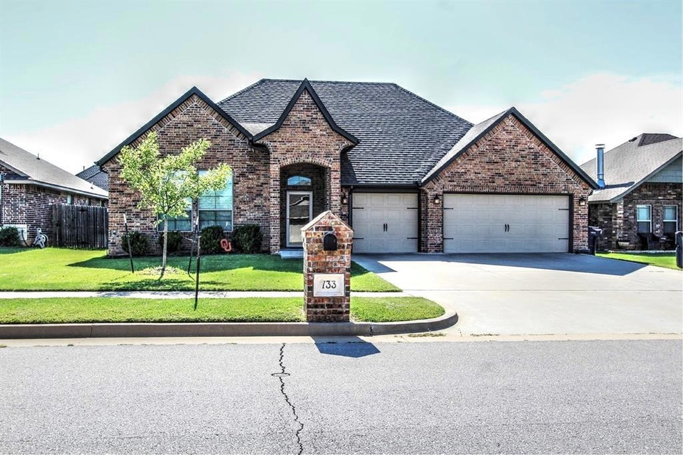 View of front of house with a garage and a front y