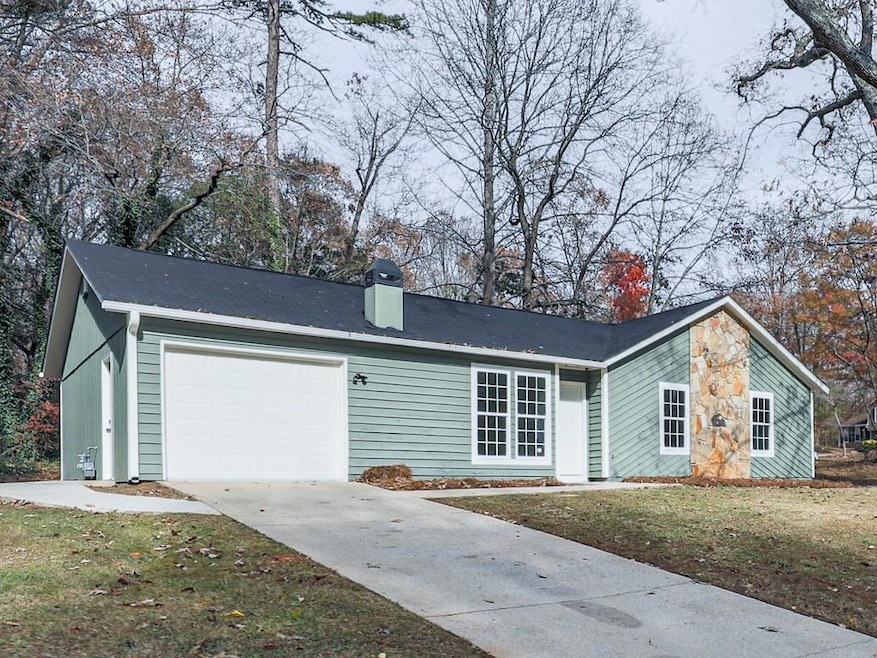 Ranch-style home with a garage and a front yard