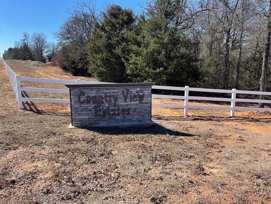 Community sign with a rural view