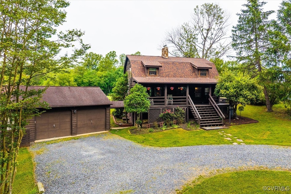 View of front of property with a chimney, roof wit