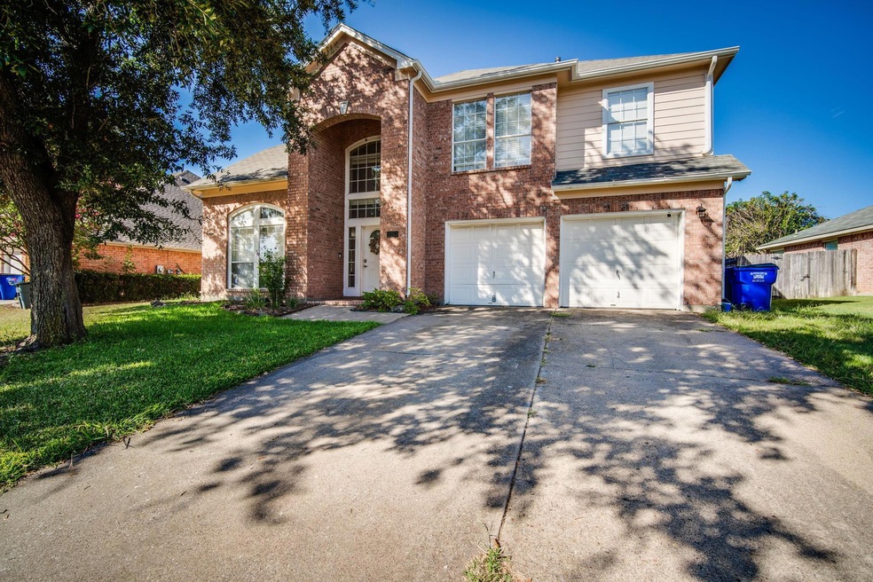 View of front of house with driveway, a garage, fe