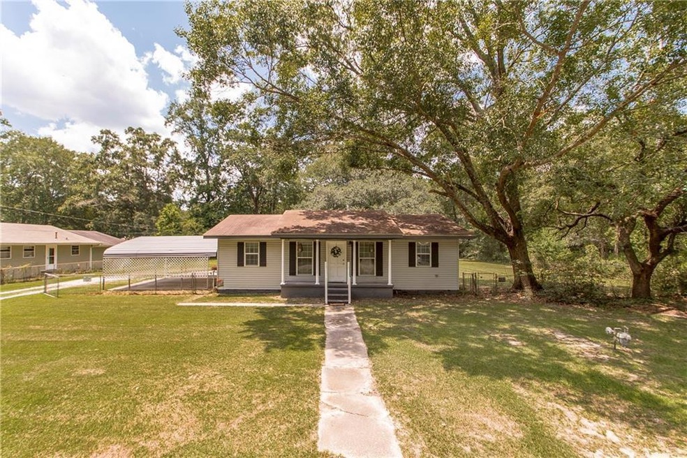 Home sits on three fenced lots. Mature shade trees