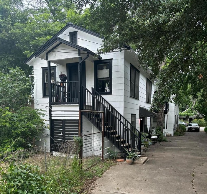 View of front of property with stairway and a por
