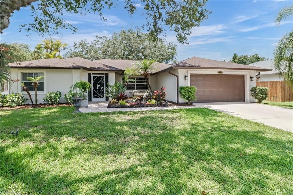 Single story home with a front yard and a garage