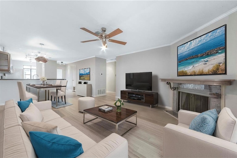 Living area featuring ceiling fan, wood finished 