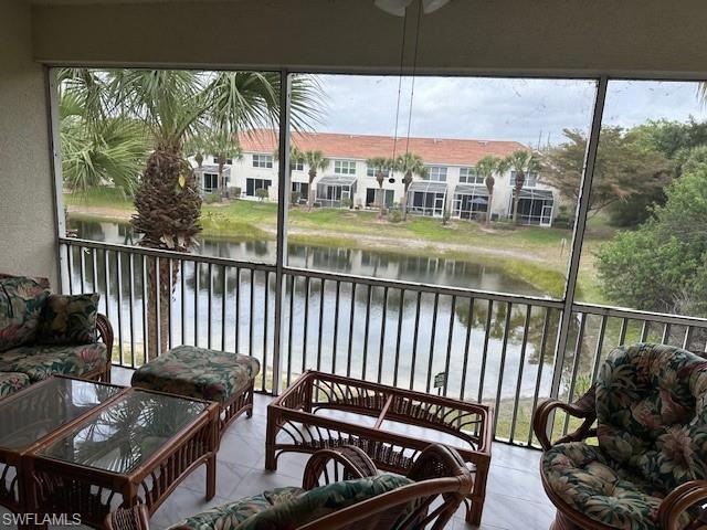Sunroom / solarium with a water view and a residen