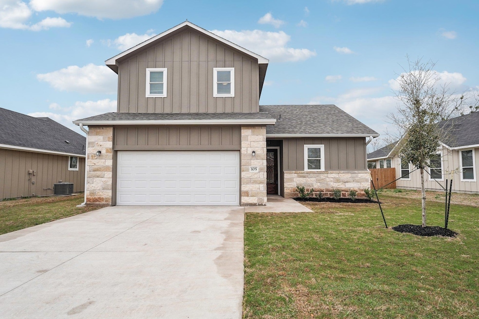 View of front of house with a front yard, drivewa