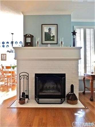 Cozy fireplace separating the living and dining ro