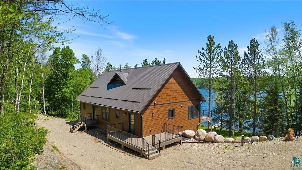 View of side of home featuring a wooden deck