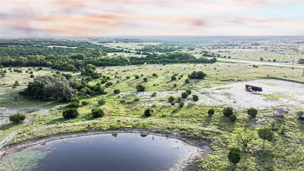 Aerial view of property and surrounding area featuring a large body of water