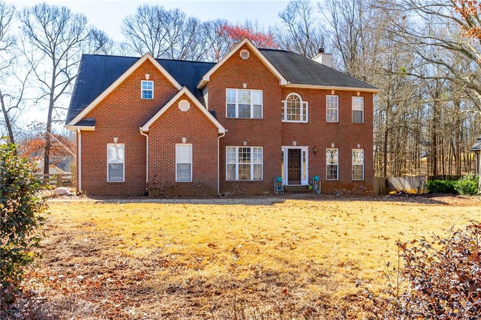 Colonial house with brick siding, a front lawn, an
