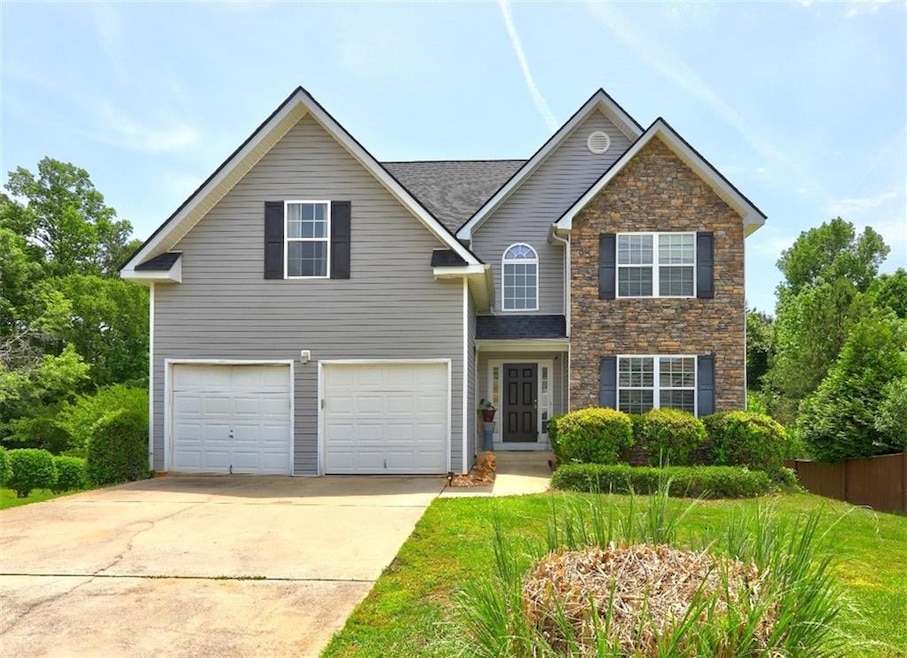 Traditional-style house featuring stone siding, an