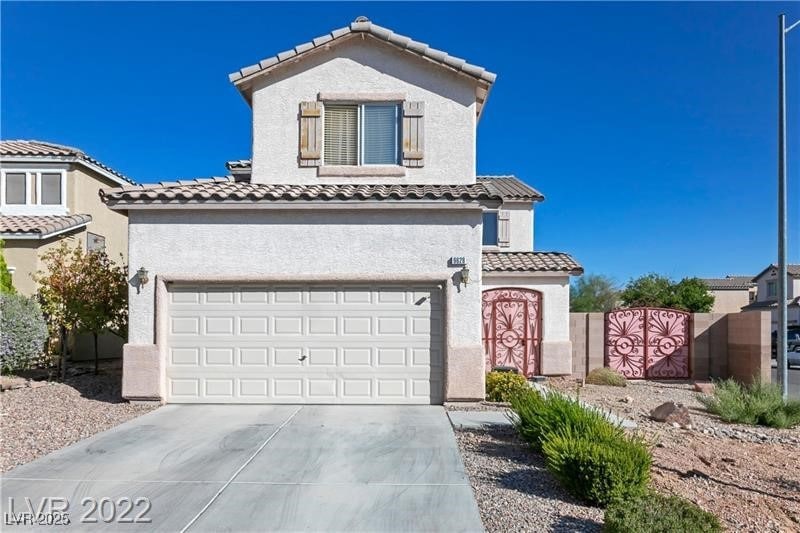 View of front of home with concrete driveway, stuc