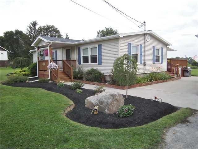 Exterior Front Tastefully landscaped corner view o