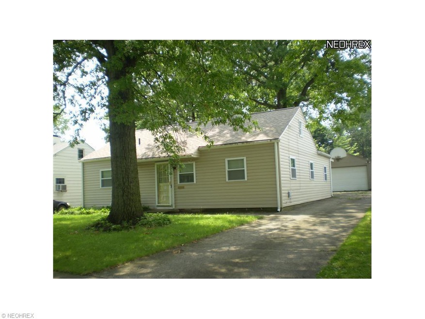 side view of property. shows 2 car garage and  con