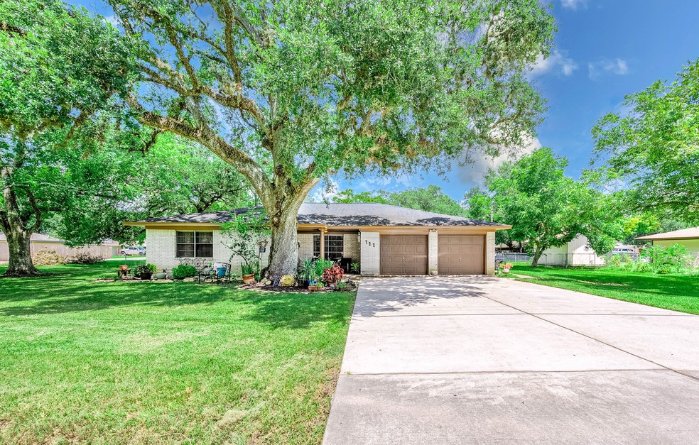 Large driveway leads you to your new home, corner lot, over 14,000 square foot lot.  Dotted with mature trees.