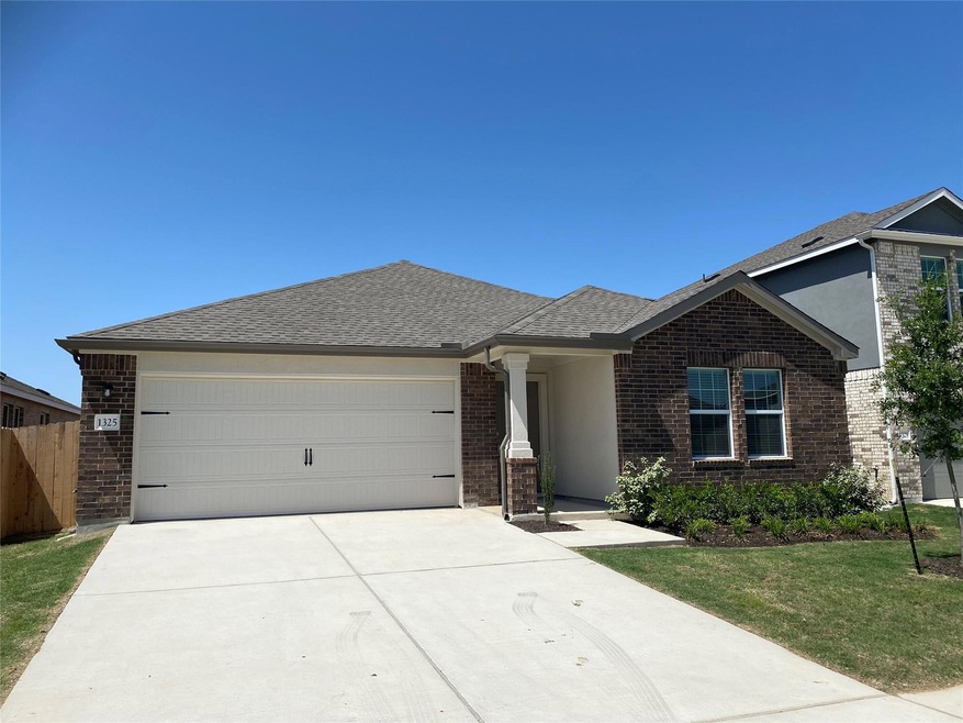 Ranch-style house with fence, a shingled roof, dr