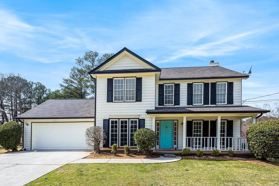 Traditional-style home with roof with shingles, a 