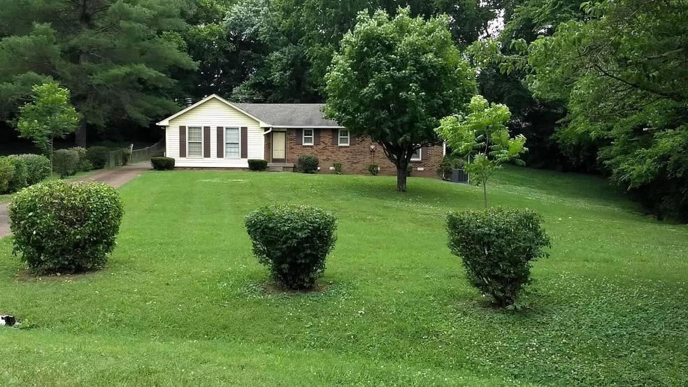 Private lot has long aggregate drive, carport, detached garage, and storage building
