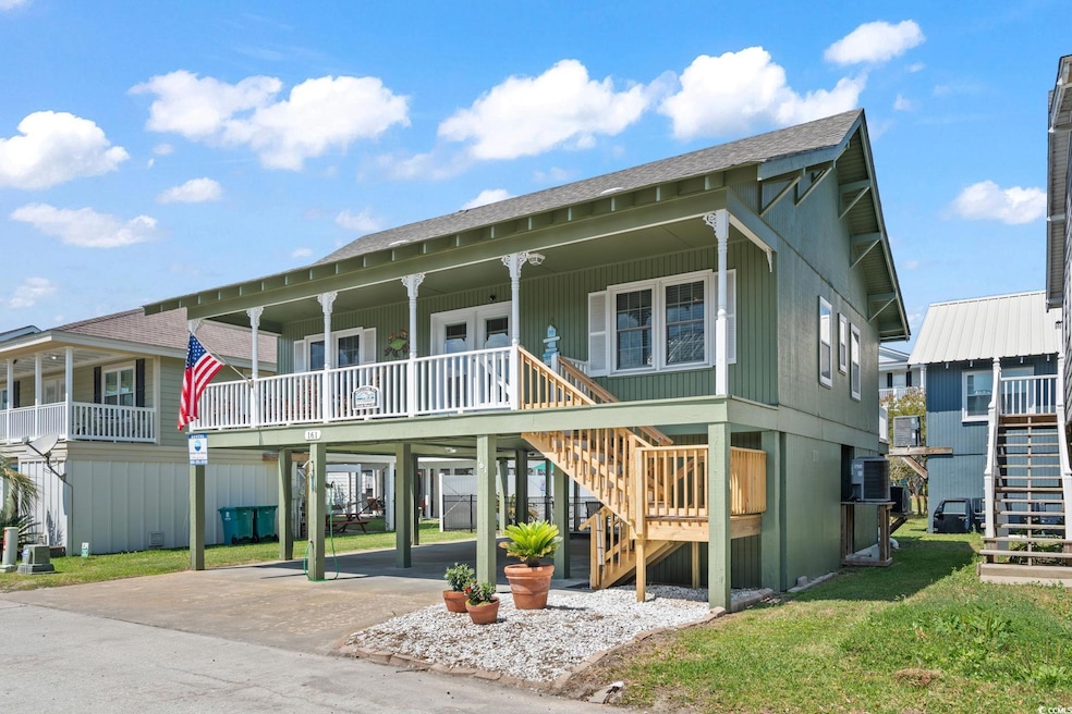 View of front of home featuring stairs, concrete driveway, a carport, roof with shingles, and covered porch