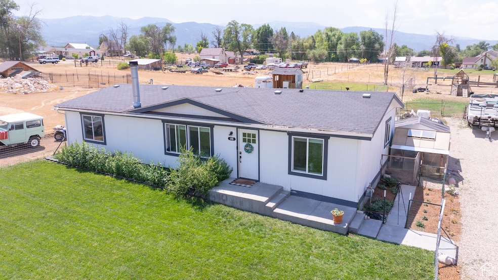 View of front of home featuring a mountain view and a shingled roof