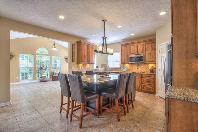 The custom kitchen is the hub of this house with its large granite island with seating for six. 