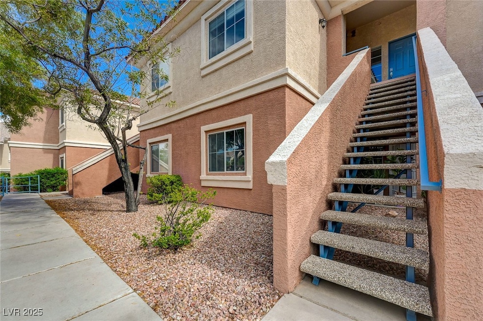 View of side of property with stucco siding and st