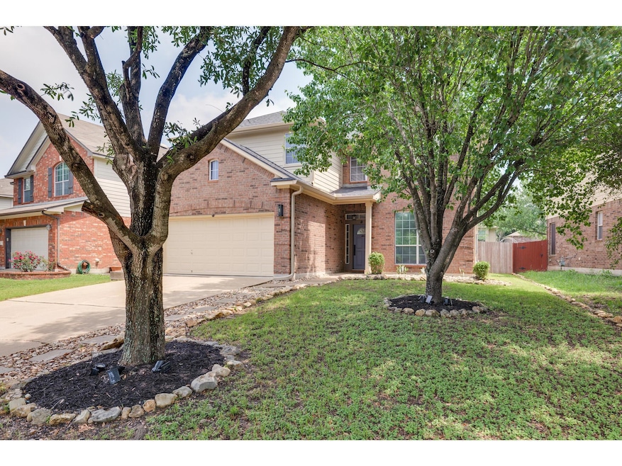 View of front of home with concrete driveway, bri