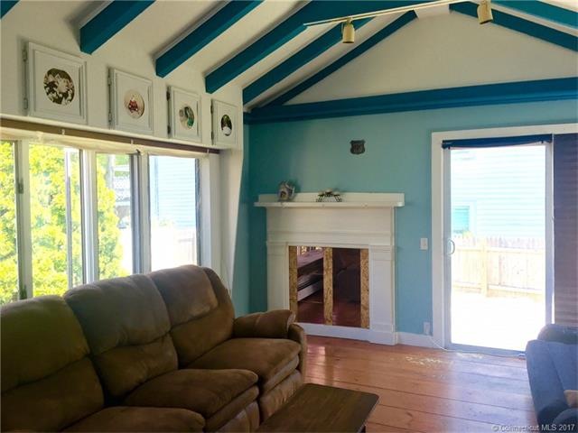Sunny living room with hardwoods and vaulted ceili