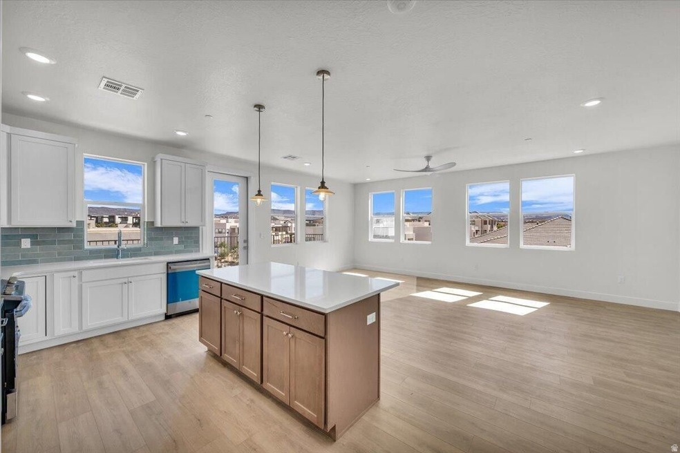 Kitchen featuring white cabinetry, open floor plan, tasteful backsplash, pendant lighting, and brown cabinetry