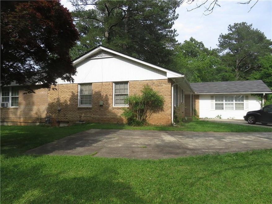 View of front facade with brick siding and a front yard