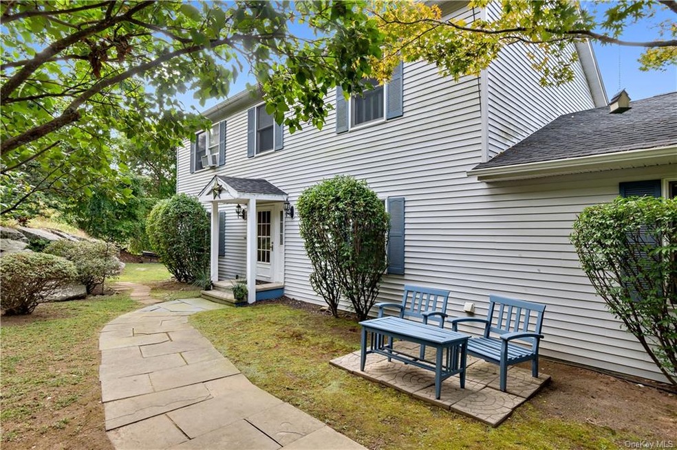 FRONT OF HOUSE WITH QUAiNT SITTING AREA