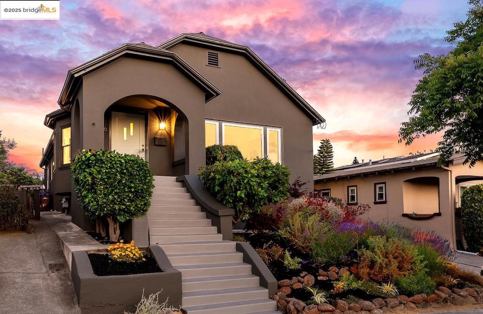 View of front of house with stucco siding and stairs