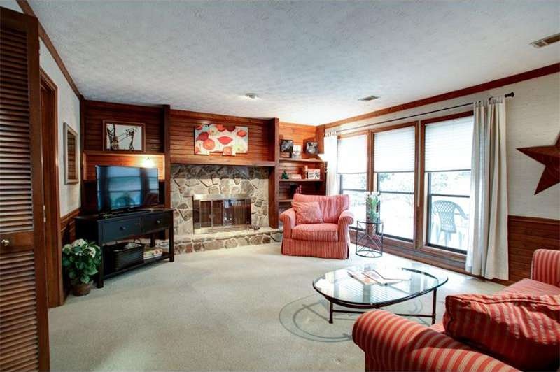 Beautiful Stone Fireplace is center focus in Huge 