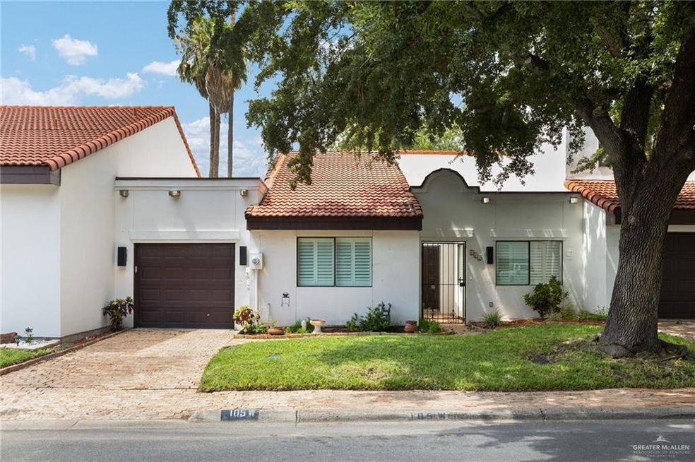 Mediterranean / spanish-style house featuring a tiled roof, driveway, an attached garage, and stucco siding
