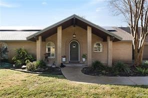 View of front of house featuring stucco siding and a front lawn