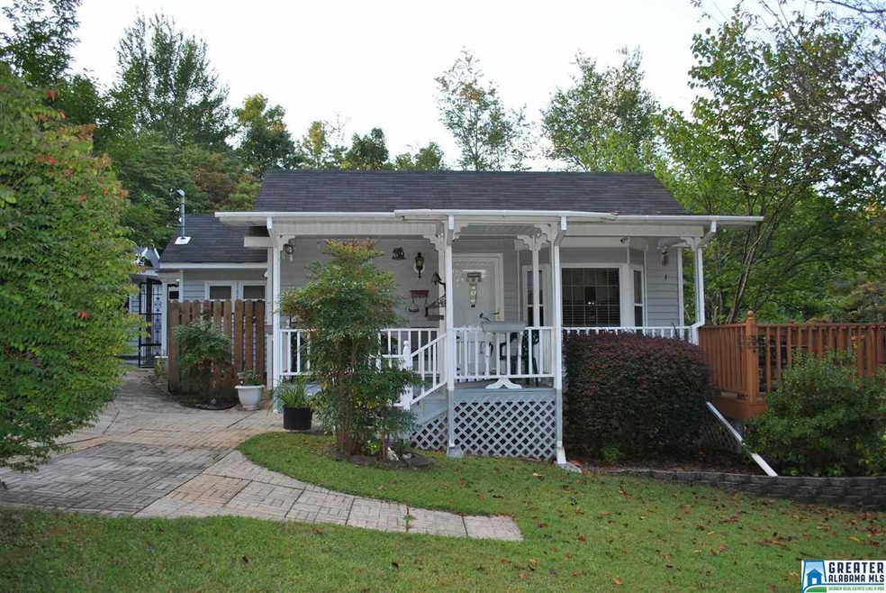 Nice front porch that has small deck on side.