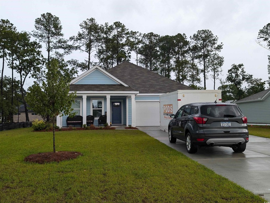 View of front of property featuring a garage and a