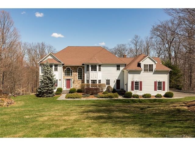 Exterior with wood clapboard and stone front.