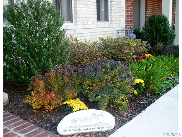 Front yard planted with Mums, Pansies, azaleas and