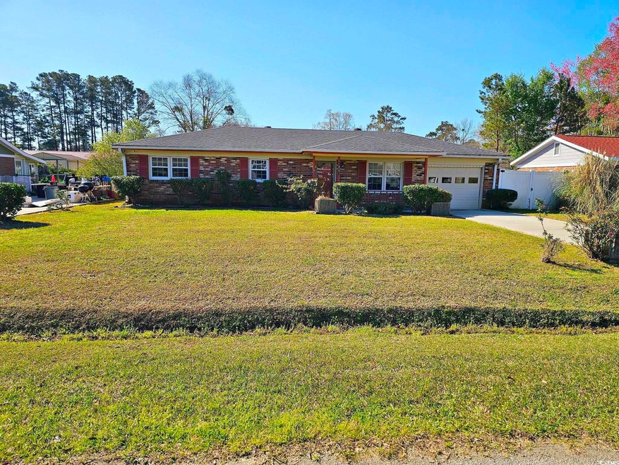 Ranch-style home with a garage, concrete driveway,